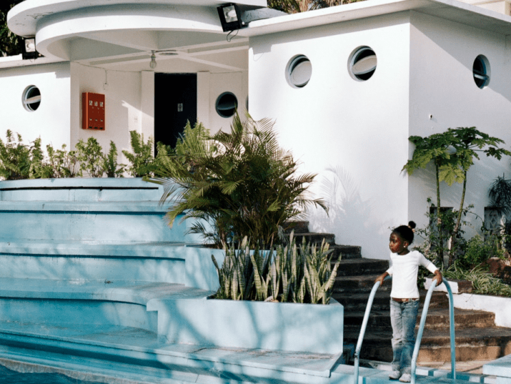 girl next to a staircase and swimming pool