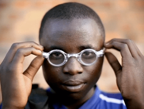 boy putting on glasses