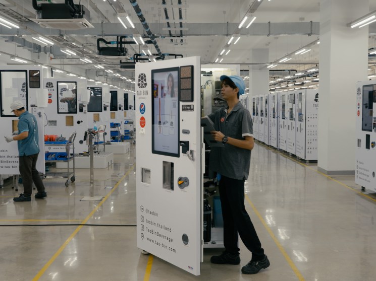 A technician looking inside a vending machine