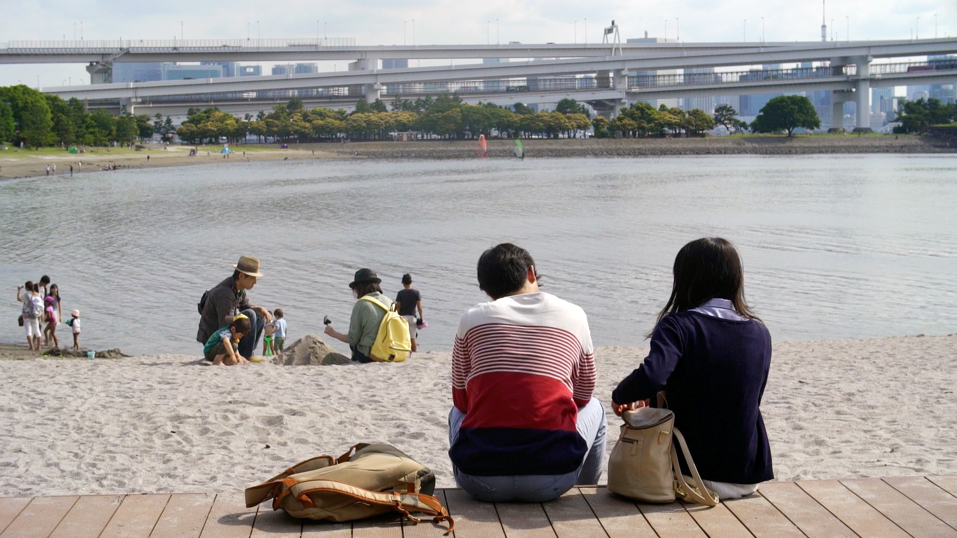 People relaxing on a beach in Tokyo.