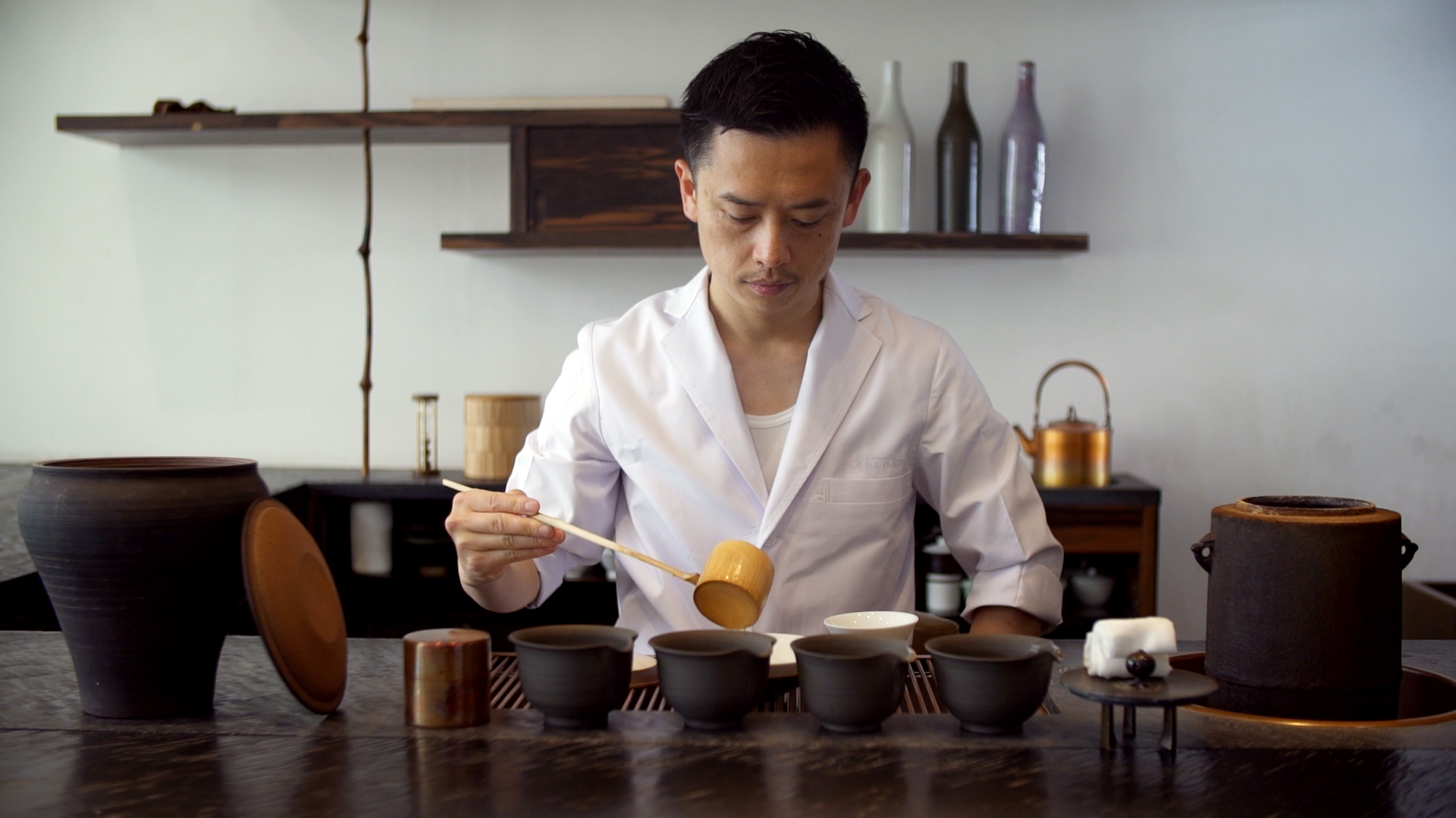 A man pouring tea into a cup.