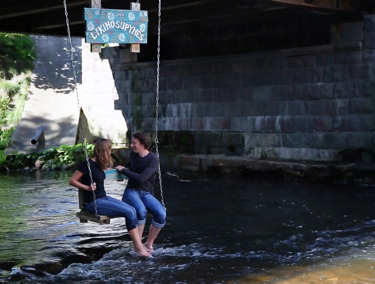 A swing hanging over the river in Uzupis.