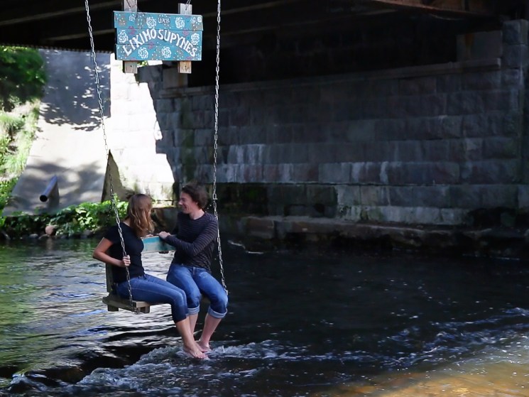 A swing hanging over the river in Uzupis.