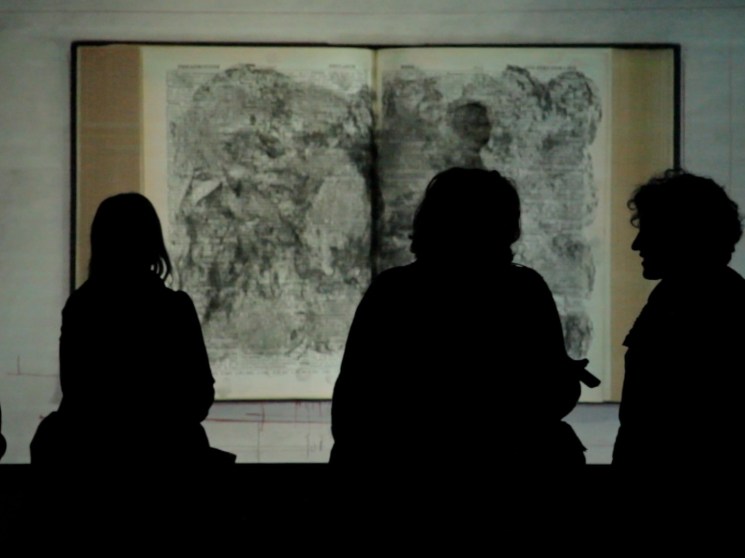 People observing a work of art.