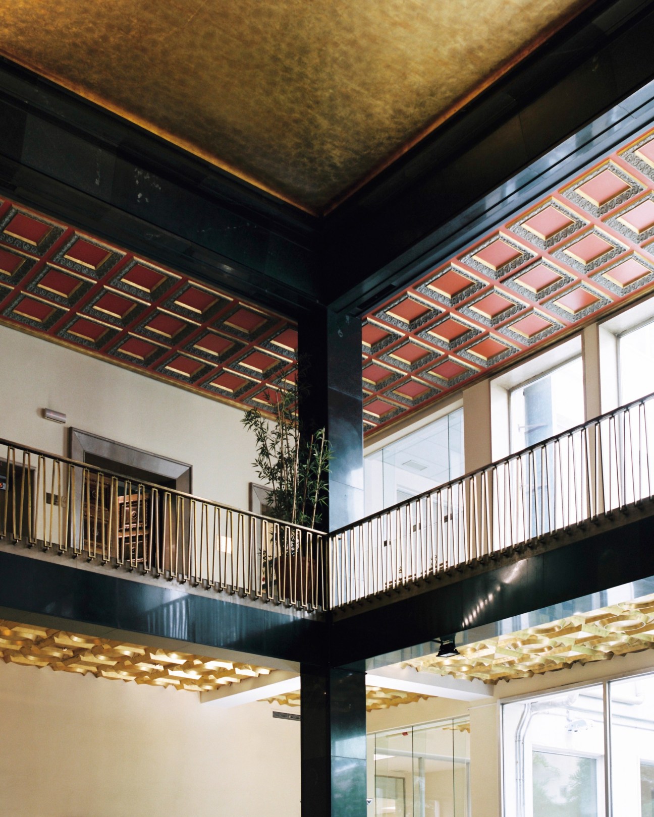 Interior of the Fabrica Nacional de Moneda y Timbre with ornate ceiling and metal railings.