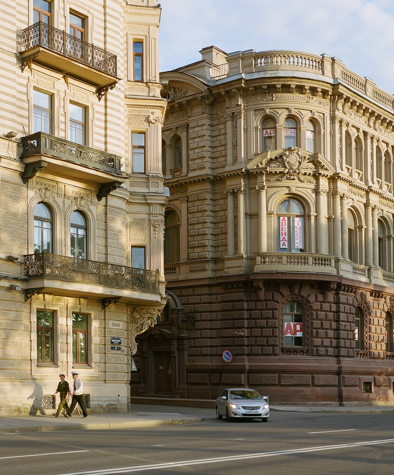 Ornate neoclassical buildings with decorative facades and wrought-iron balconies on Admiralteyskaya embankment in St Petersburg.