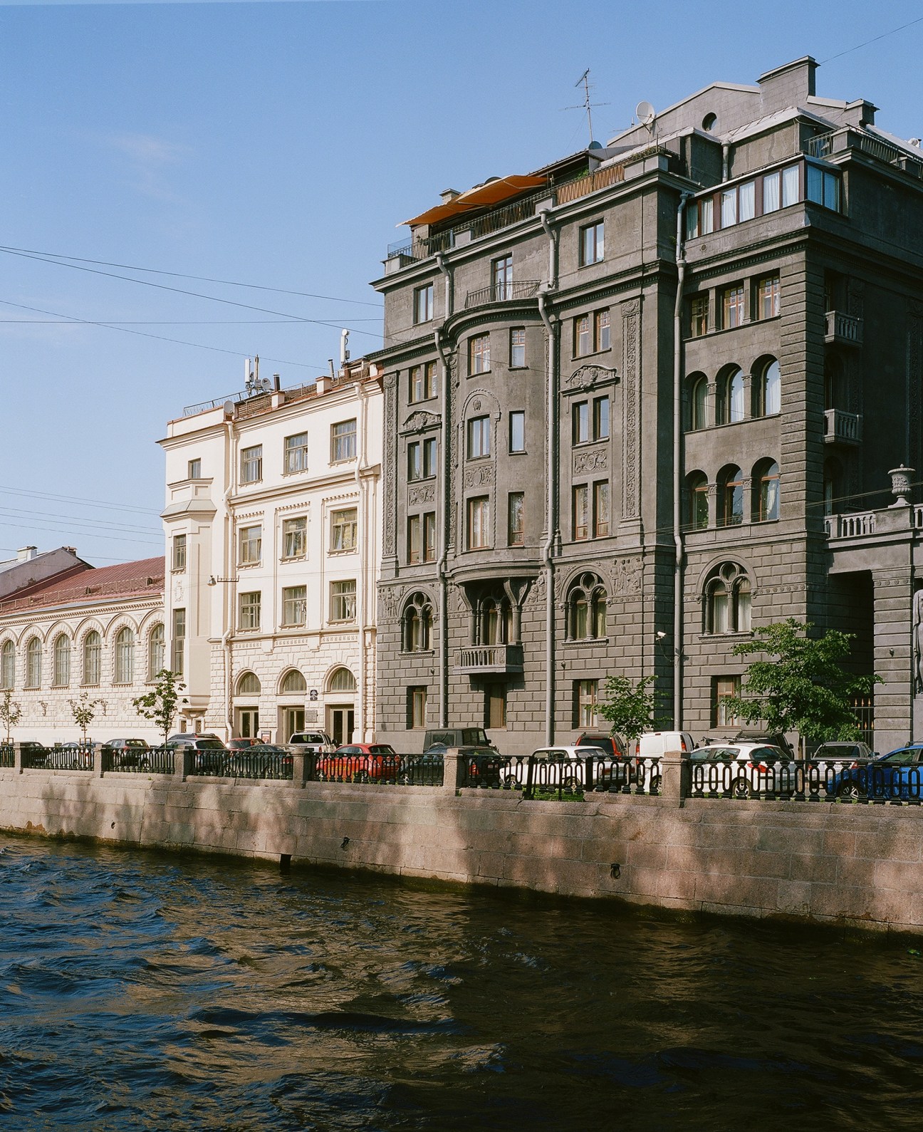 Historic buildings along a canal in St Petersburg, including the Wege House with classical architecture.
