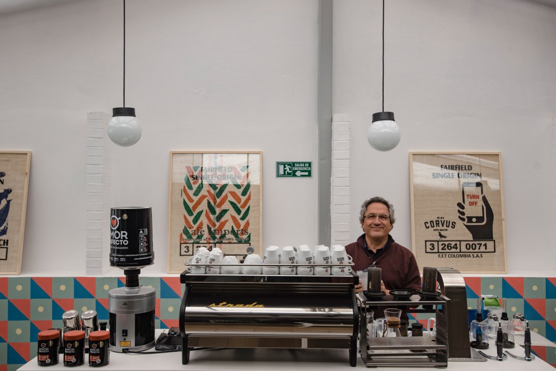 Luis Fernando Velez stands behind the counter at Union Libre coffee shop in Usaquén, Bogotá.