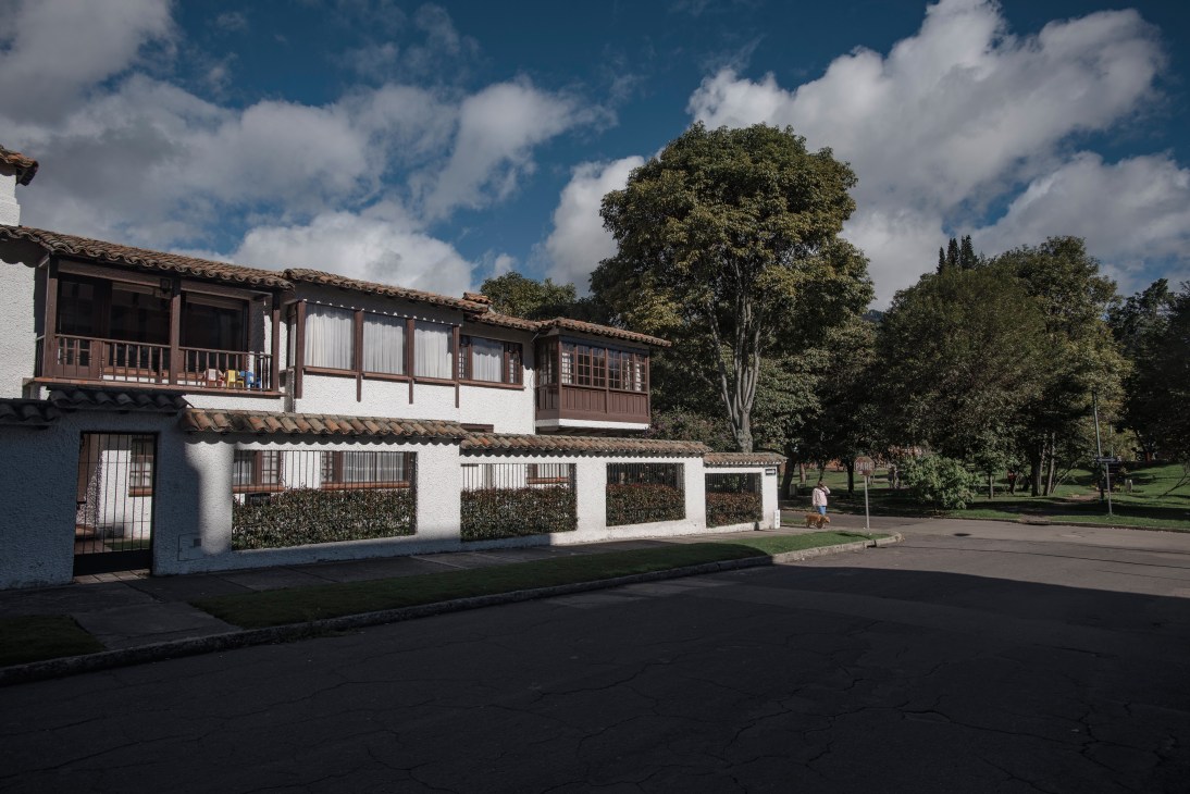Colonial-style white house with wooden balcony and terracotta roof in Usaquén, Bogotá
