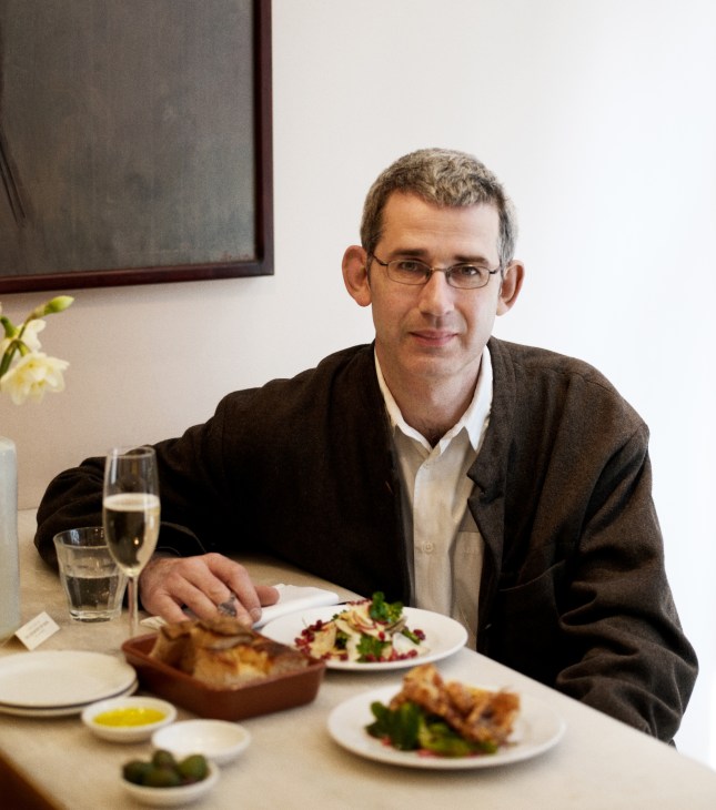 Ceramic artist Edmund de Waal seated at a table with his last meal at Bocca di Lupo restaurant.