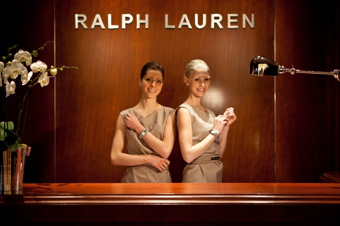 Two models display watches at the Ralph Lauren stand during SIHH.
