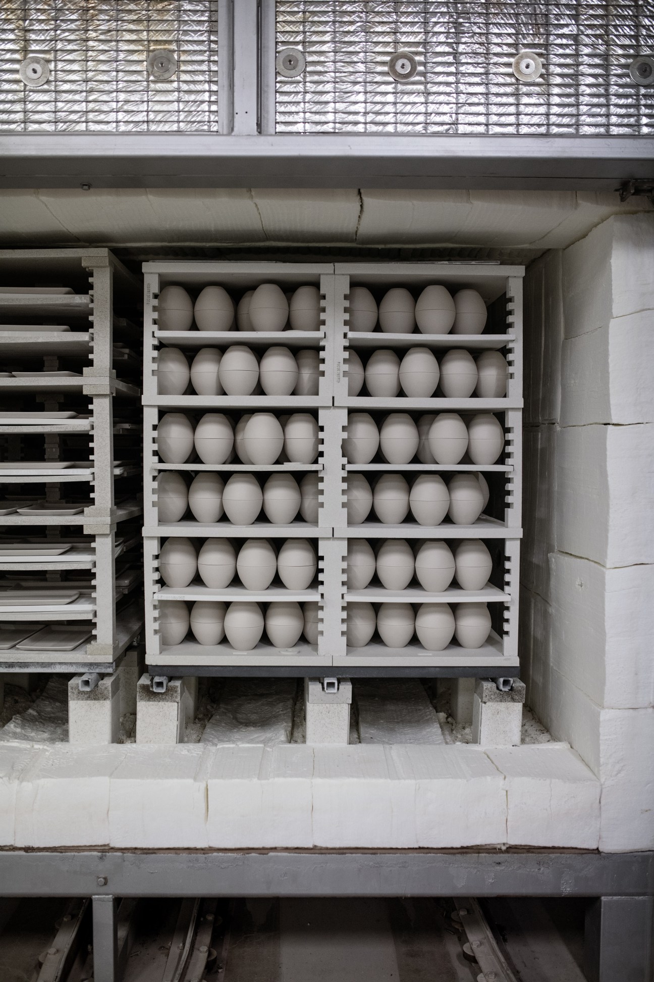 White plaster moulds for porcelain production arranged in shelving at Figgjo factory.