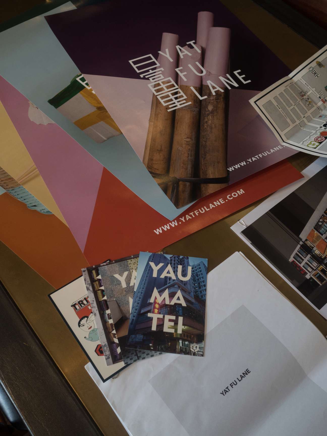 District15 marketing materials and branding displayed on a wooden table, including colorful brochures and publications.