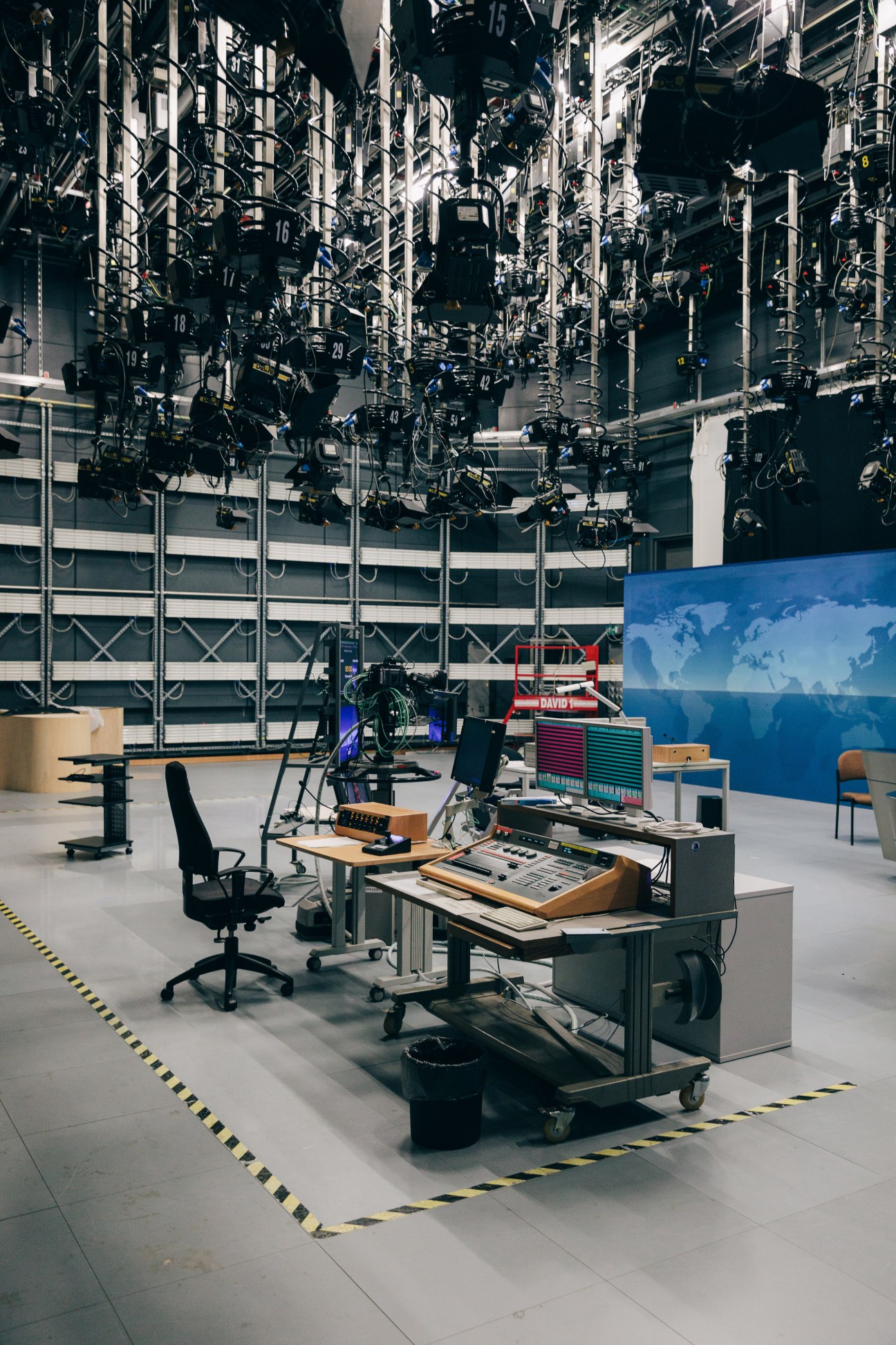 Tagesschau backup studio with overhead lighting rigs, control desk, and world map backdrop.