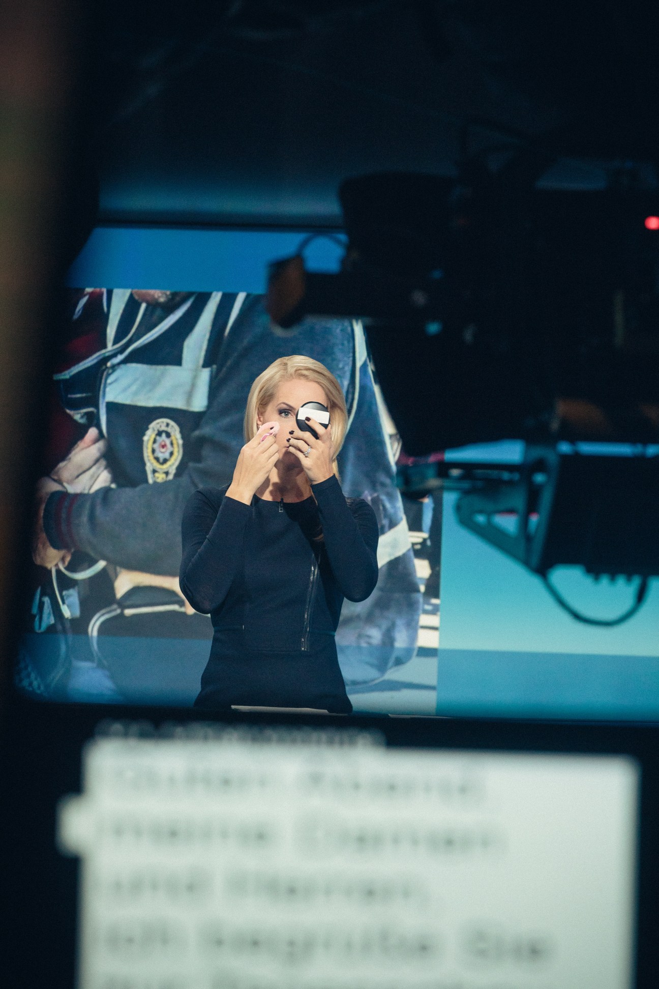 Tagesschau presenter Judith Rakers applying makeup in the studio before broadcast.