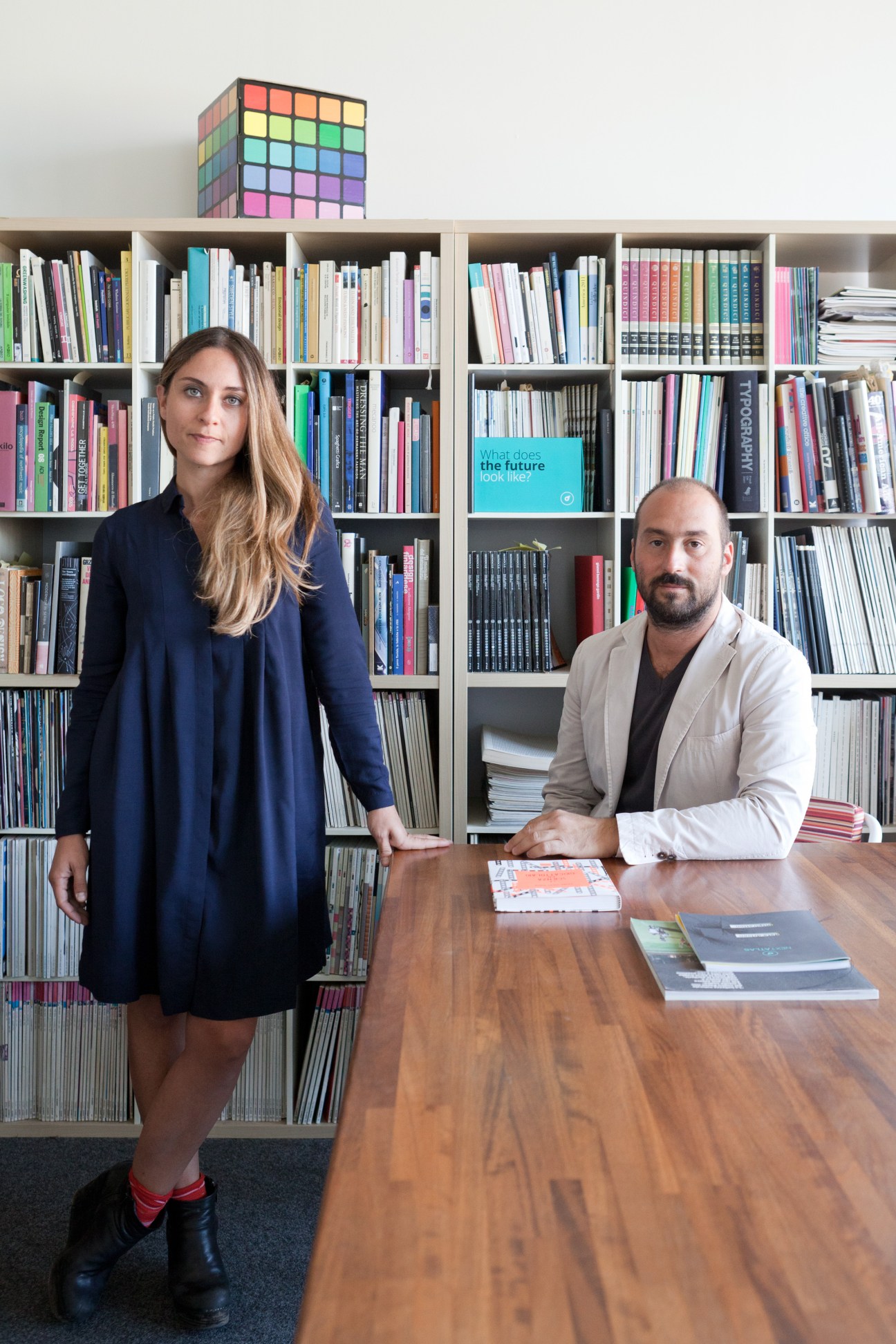 Bellissimo owner Luca Ballarini and partner Barbara Villanova in their office with bookshelves and a Rubik's cube.