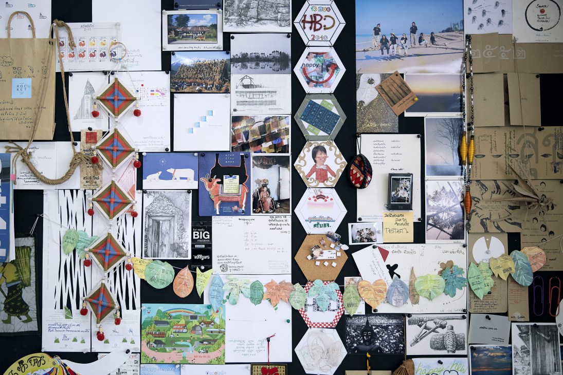 A collage of architectural sketches, design drawings, photographs, and inspiration materials pinned to a dark wall.