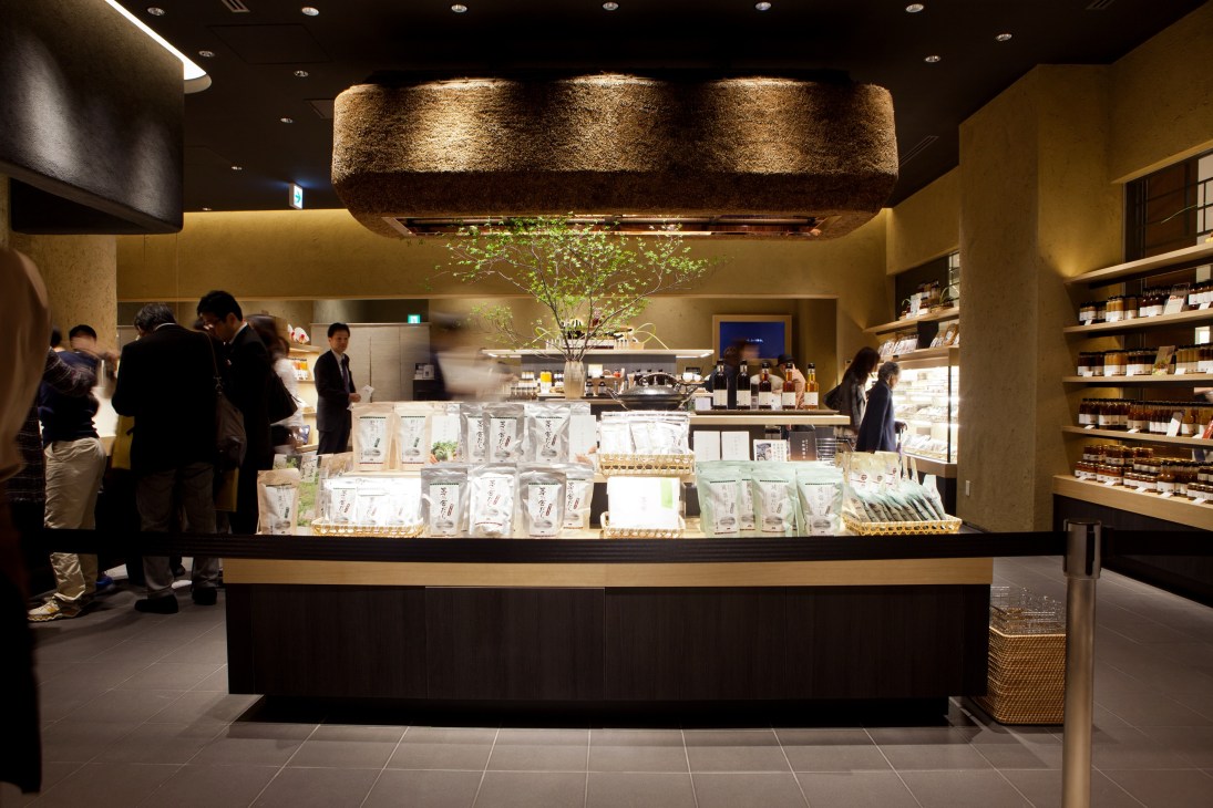 Interior of Kayanoya store at Tokyo Midtown with counter display, customers, and shelved products.