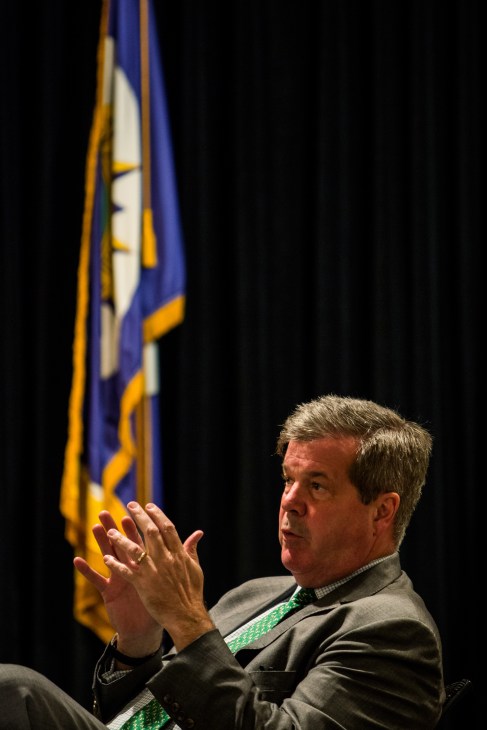 Outgoing Nashville mayor Karl Dean gestures while speaking, with a Tennessee flag in the background.