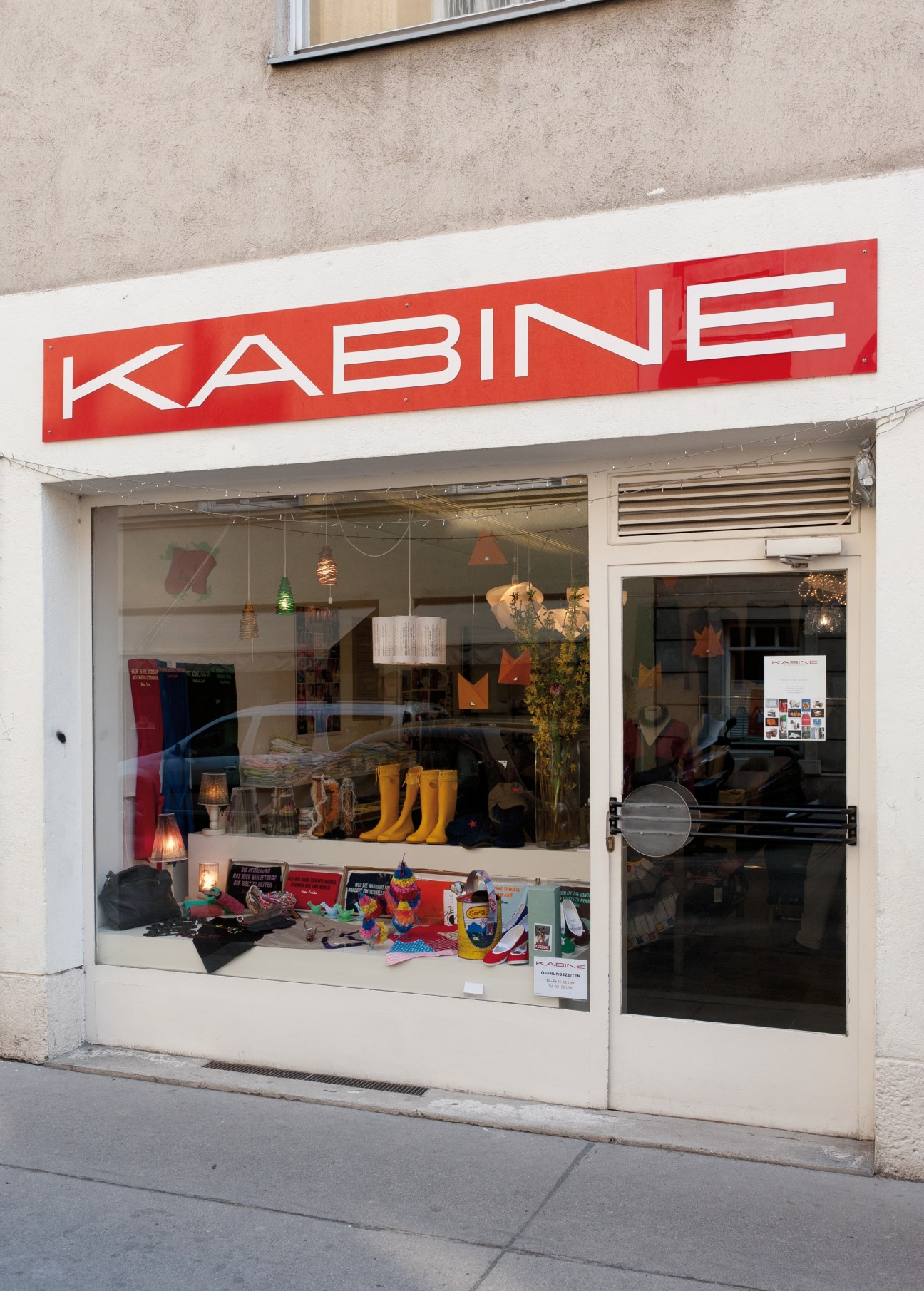 Kabine boutique storefront with red sign displaying clothing and homeware in Vienna