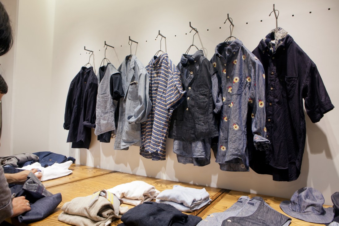 Denim and casual shirts displayed on hangers at 45R store in Tokyo Midtown.