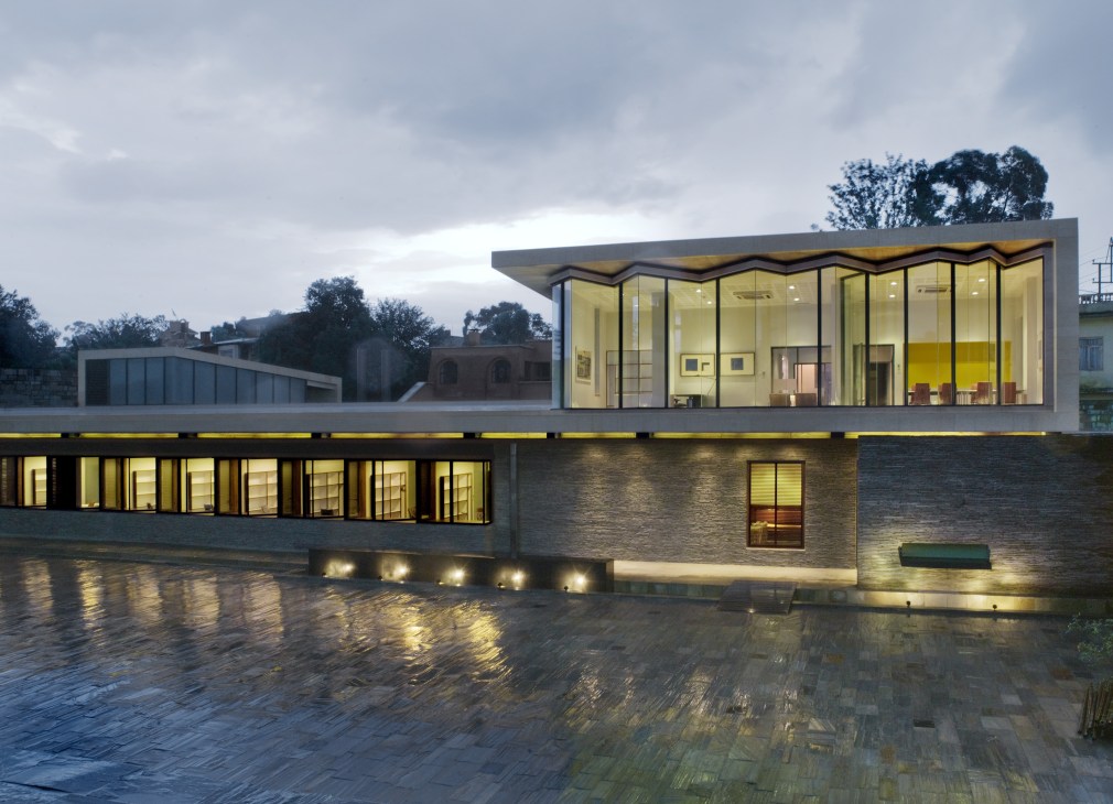 Norwegian embassy in Kathmandu featuring modern architecture with large floor-to-ceiling windows, natural materials, and mountain views.