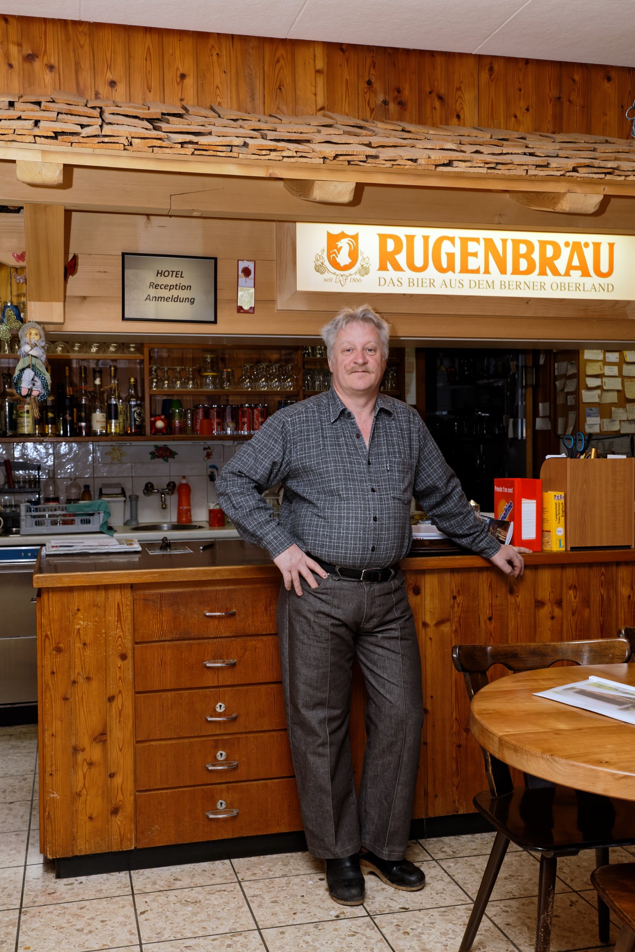 Kurt Balmer, co-owner of Hotel Alpenrose, stands at the bar counter of his establishment in Saxeten.
