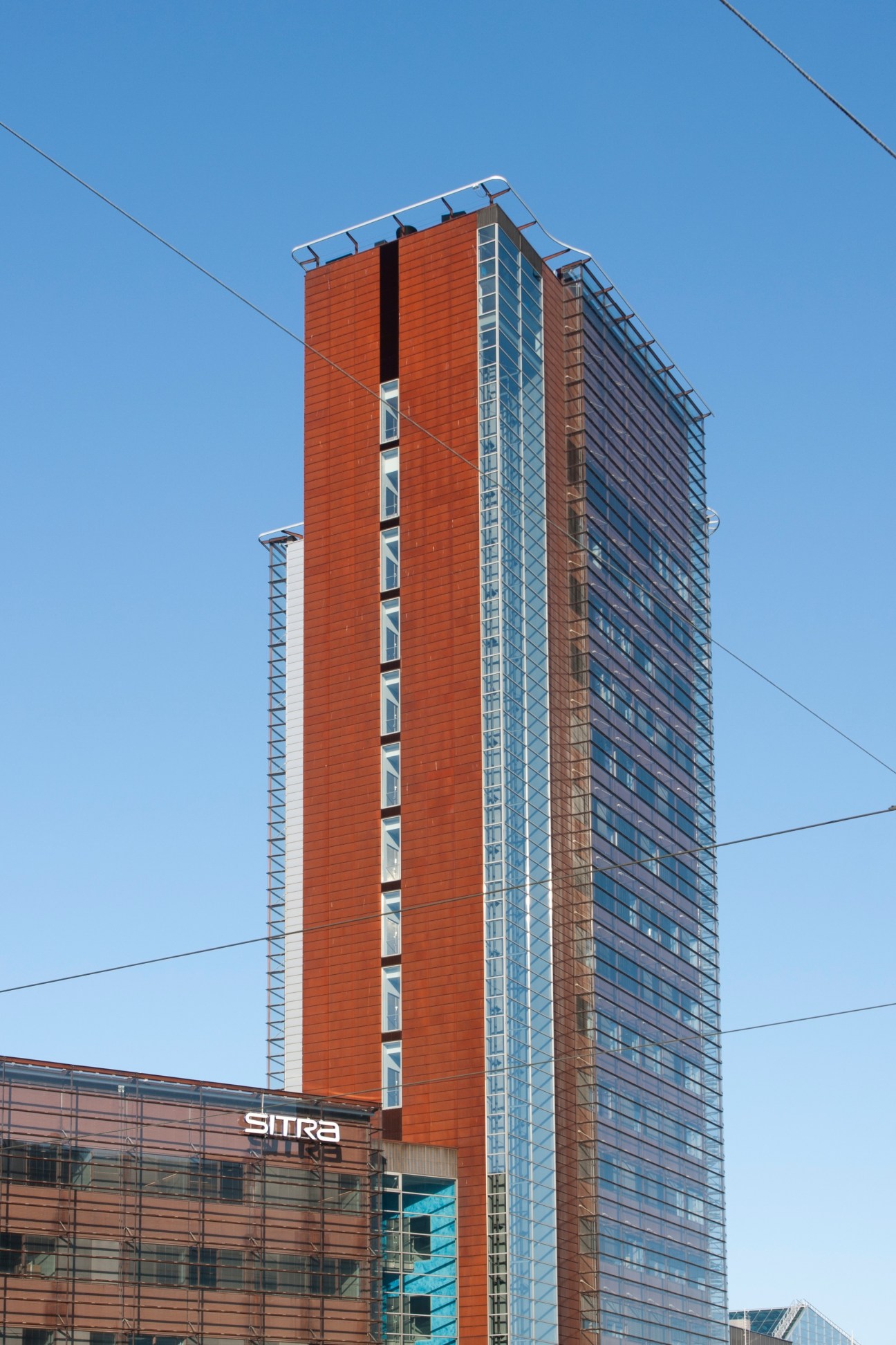 Sitra headquarters, a tall modern building with red brick and glass facade in Helsinki.