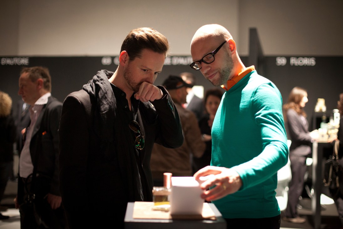 Two men sample fragrances at the Humiecki & Graef stand during the Esxence trade fair in Milan.