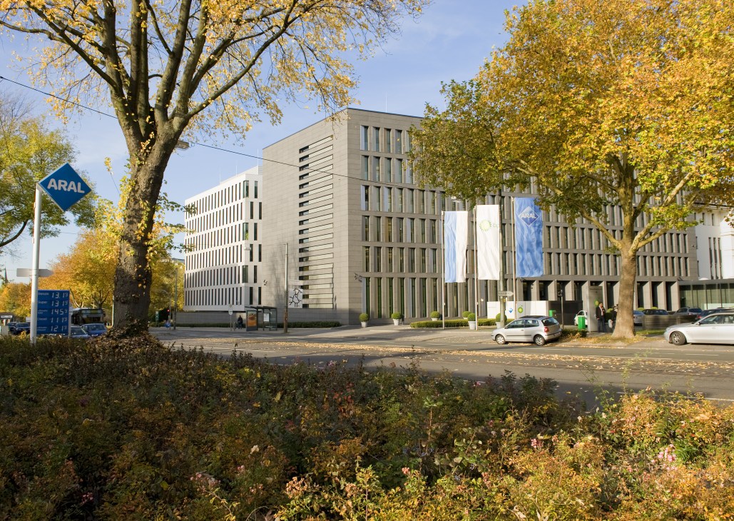 Aral's modern headquarters building in Bochum with autumn foliage and signage visible.