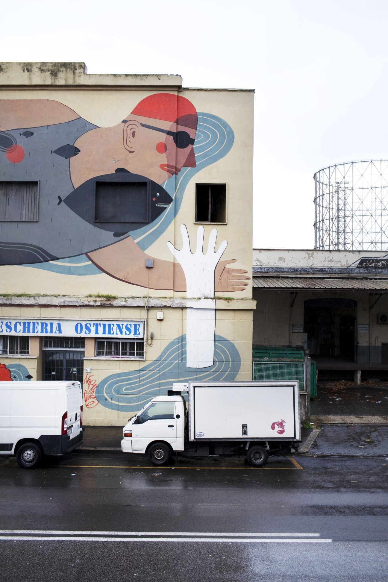 Colorful street mural on Ostiense building featuring abstract portrait with geometric shapes