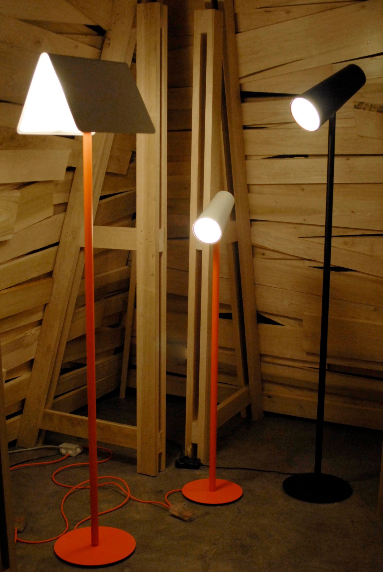 Landmarks floor lights for Established & Sons by Sylvain Willenz displayed against wooden wall backdrop.