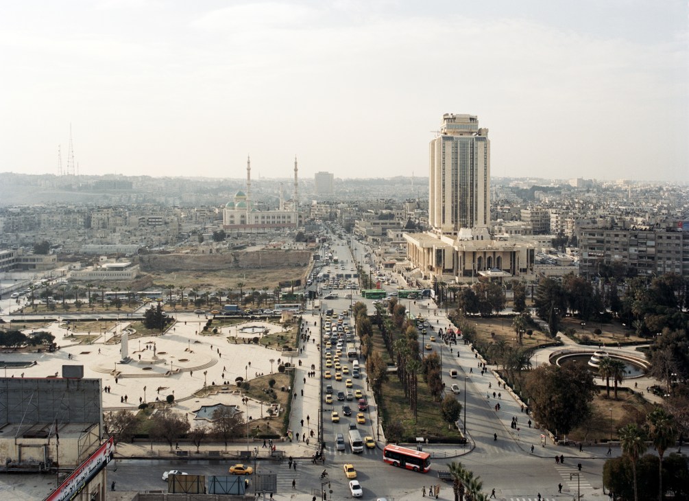 Aerial view of Aleppo showing the town hall and cityscape with mosques and residential buildings
