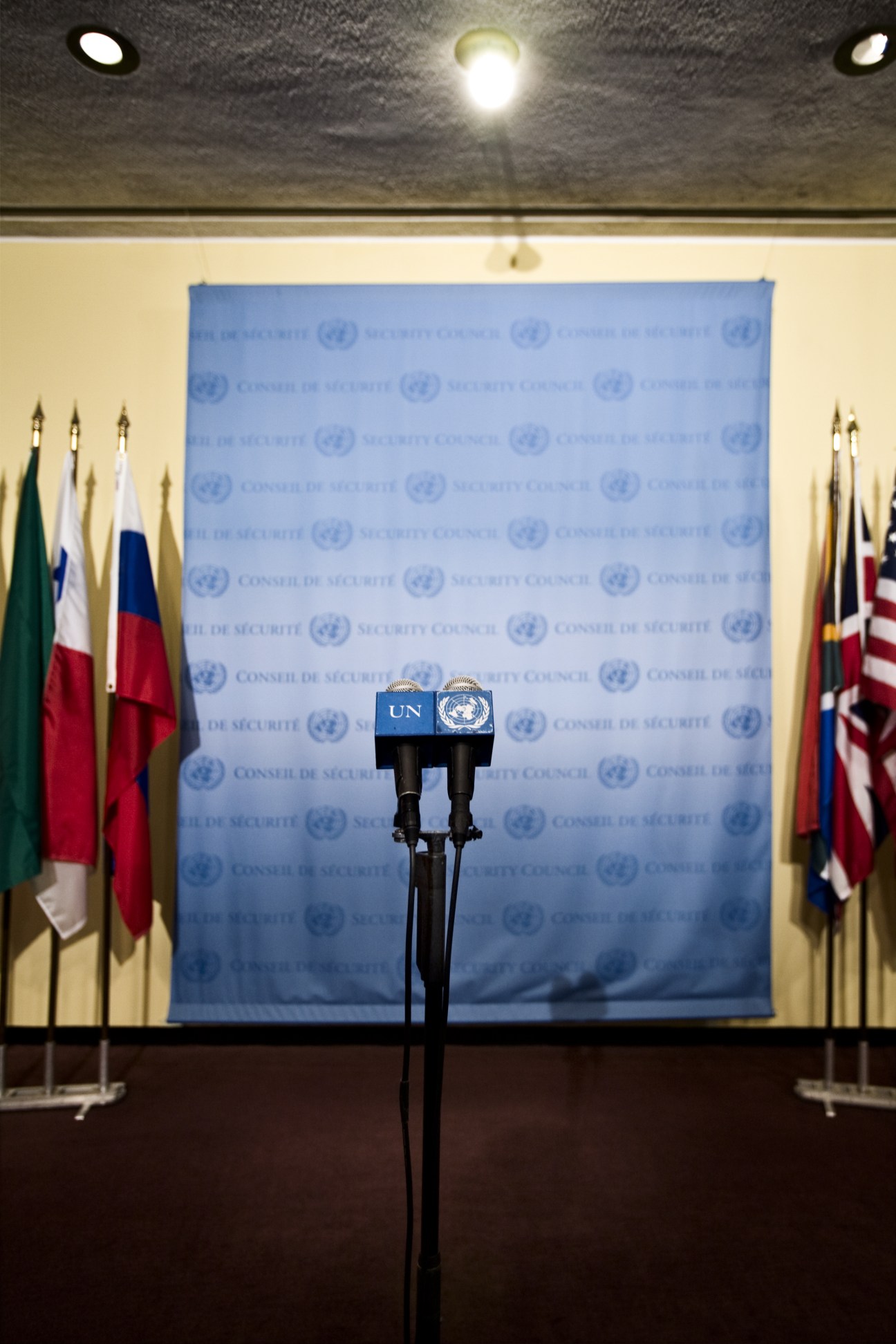 UN Security Council press conference podium with microphones and flags in background