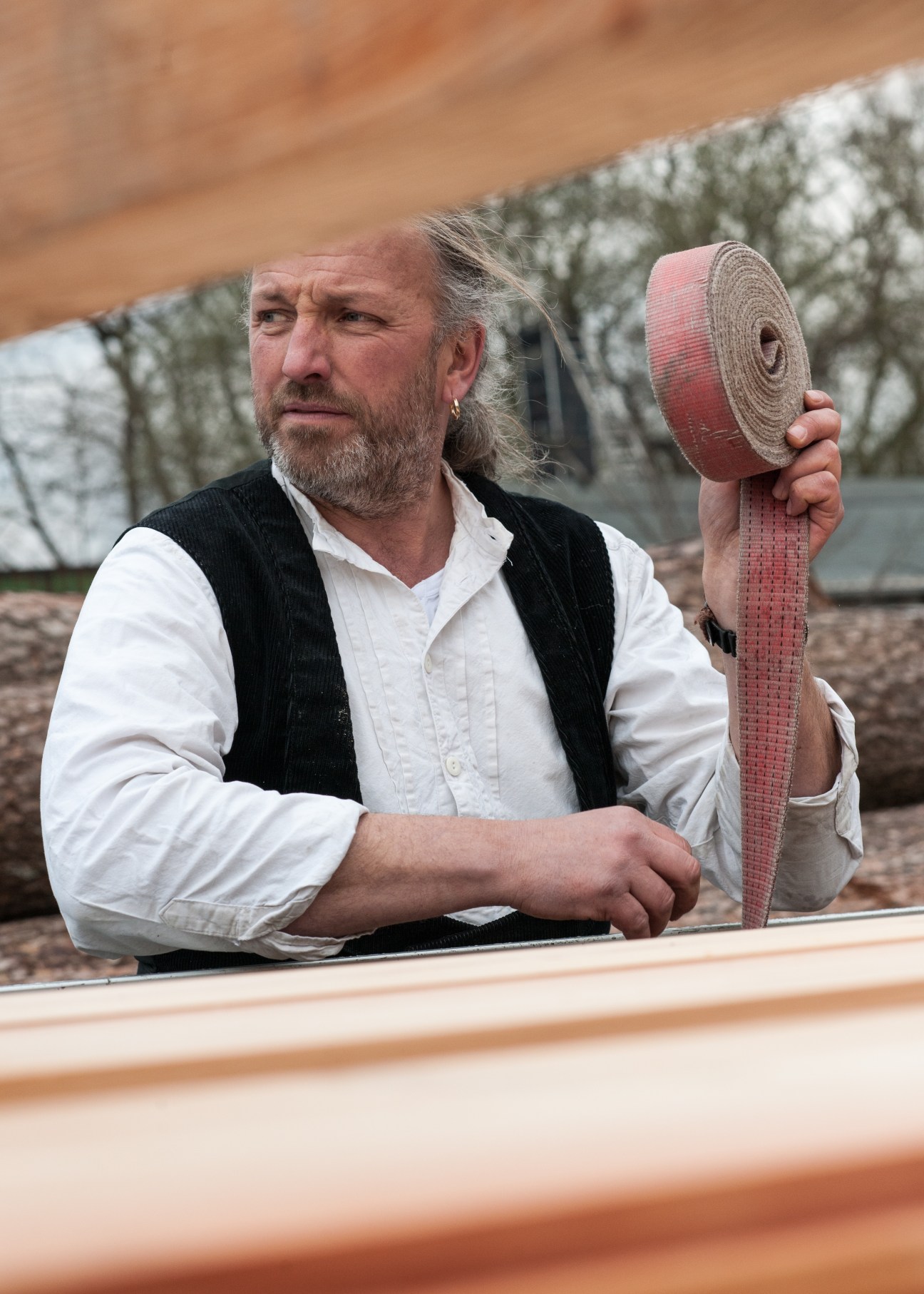 Master carpenter Martin Kottmeier holds a roll of red measuring tape at his Hamburg workshop.