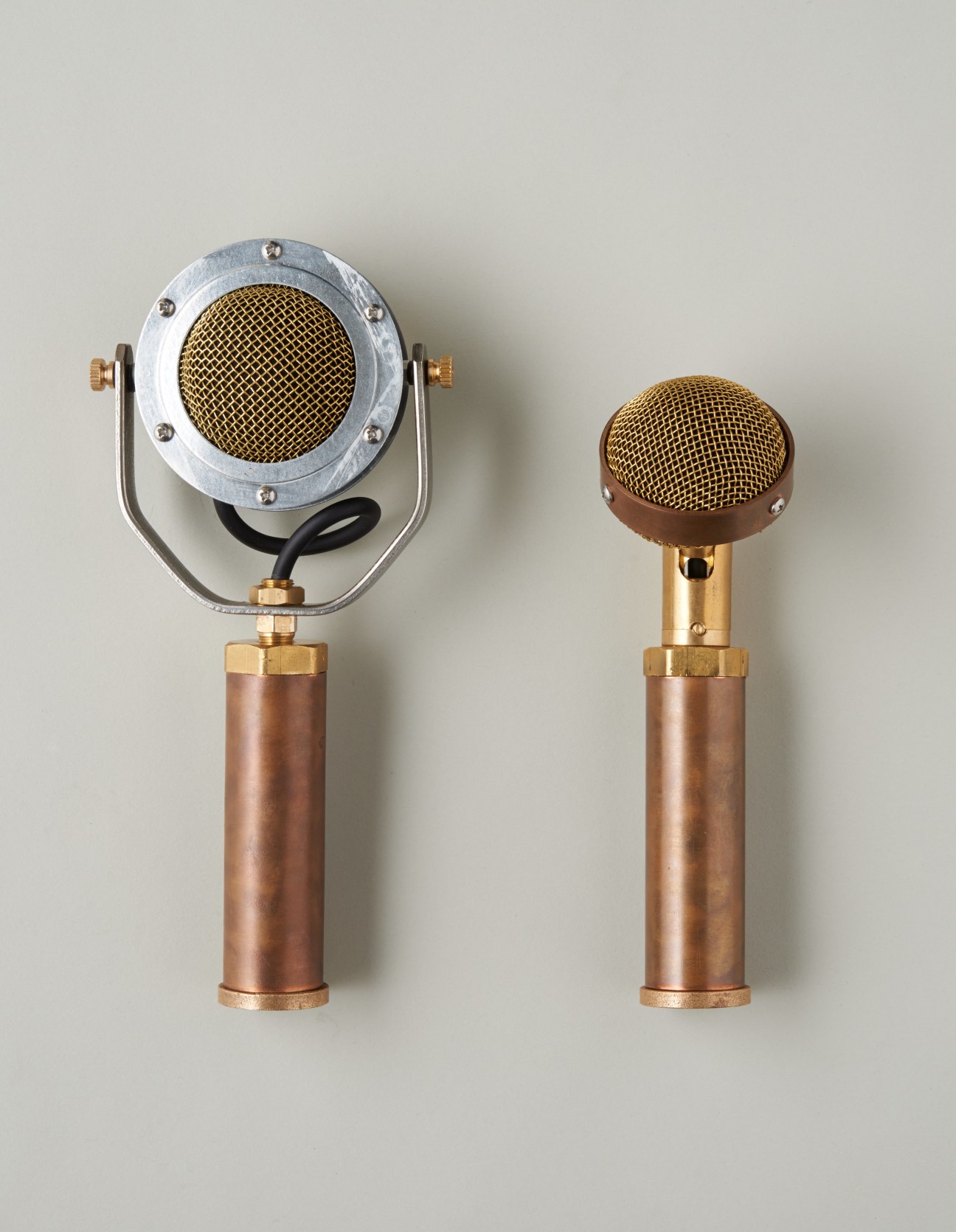 Two handmade microphones with copper bodies and mesh grilles by Graham's Ear Trumpet Labs.