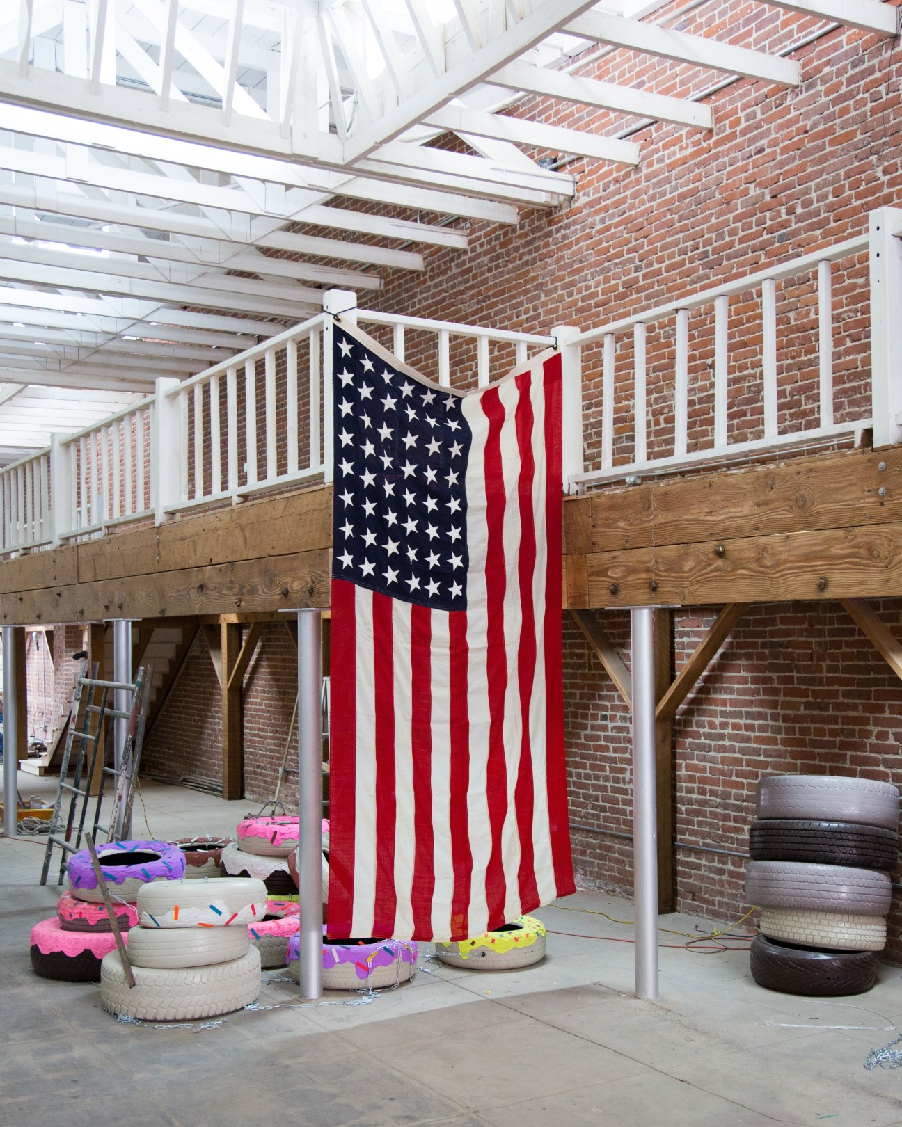 American flag hanging in an industrial brick workshop space at Factory LA