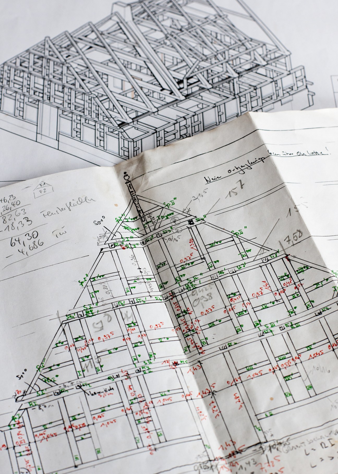 Architectural drawings and sketches of timber house construction with detailed measurements and annotations in green and red ink.