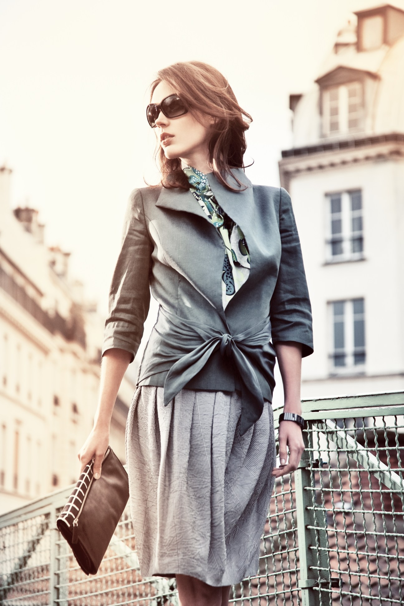 Model wearing Tonello jacket and blouse with Incotex skirt on Parisian balcony.