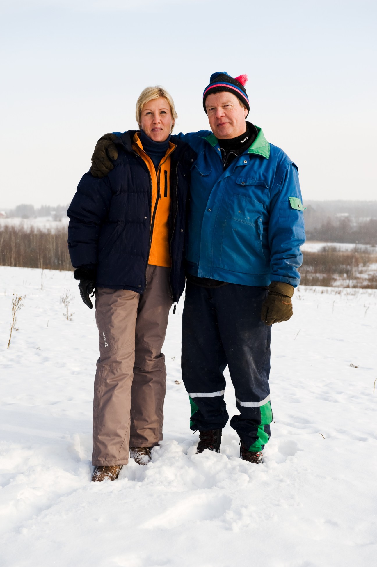 Erja Räty and Hannu Salminen standing together in snowy landscape wearing winter clothing.