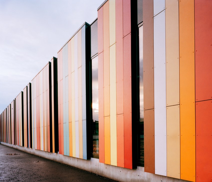 Colorful striped fibre-concrete panels on Oslo International School's lower primary block facade.