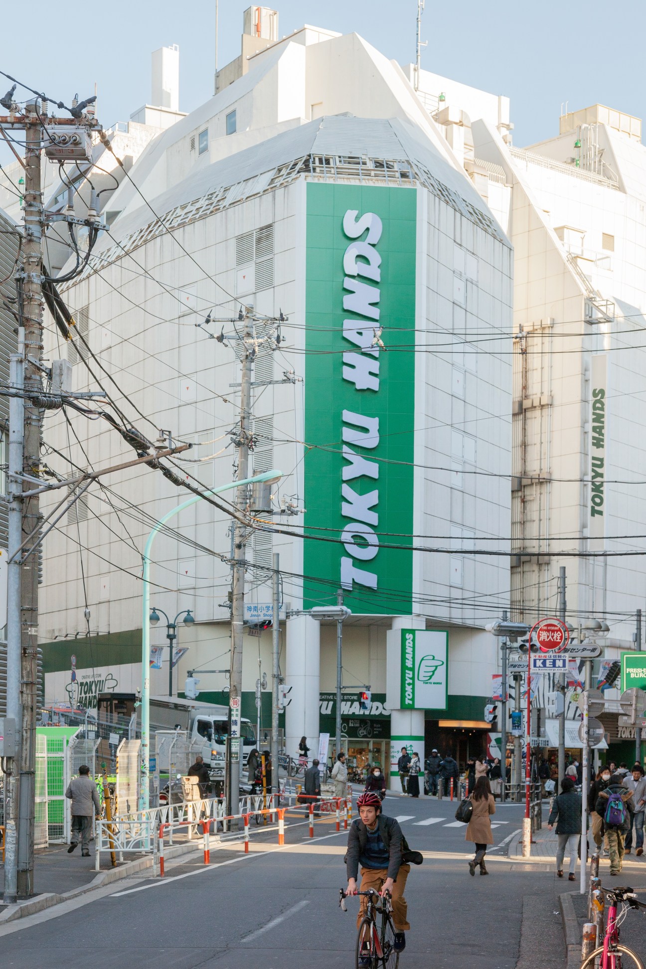 Tokyu Hands Shibuya store exterior with large green signage on corner building in Tokyo.