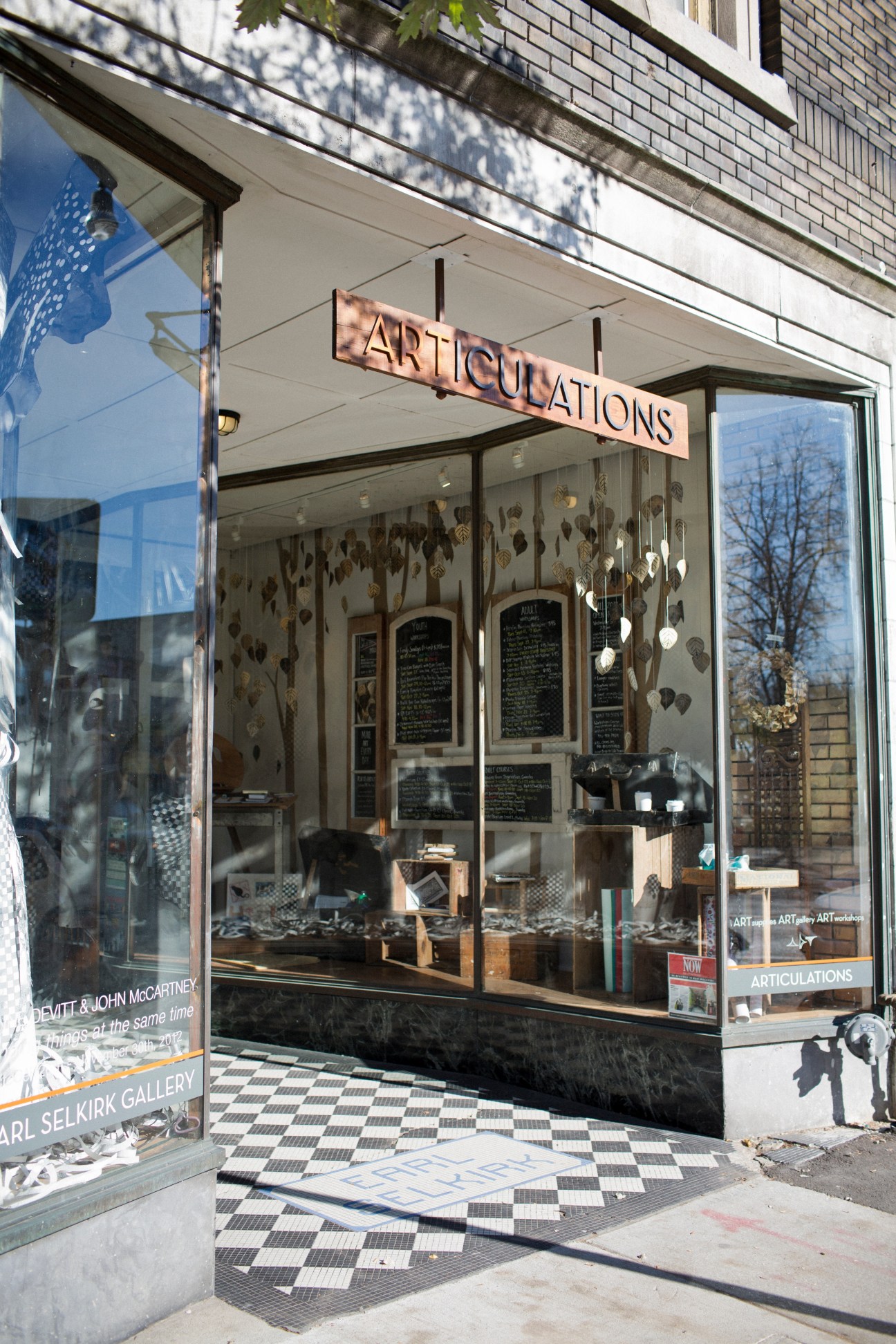 ARTiculations stationery shop storefront with neon sign and black-and-white checkered floor in the Junction neighbourhood.