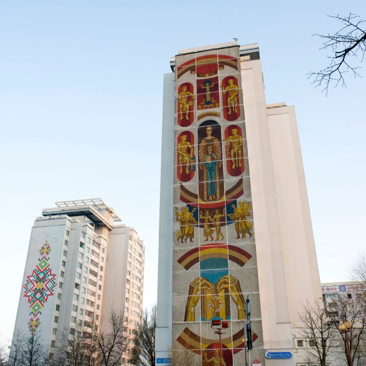 Soviet-era apartment buildings in Minsk with decorative folk art mosaics on the facades.