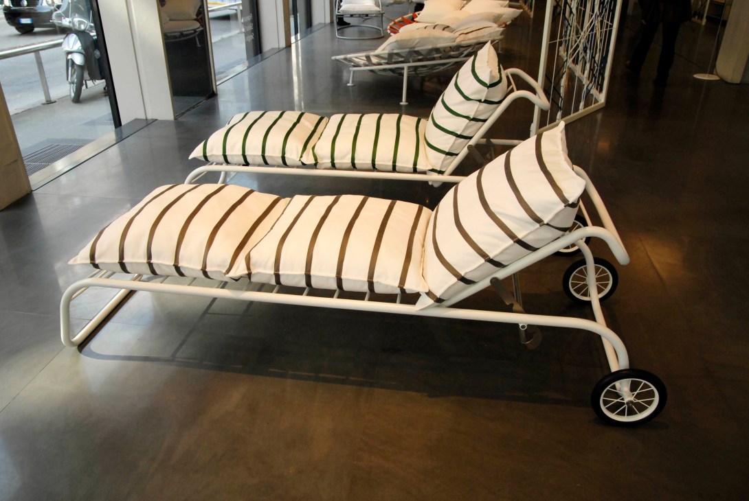 De Padova Framura sun loungers with striped cream and brown cushions displayed in a showroom