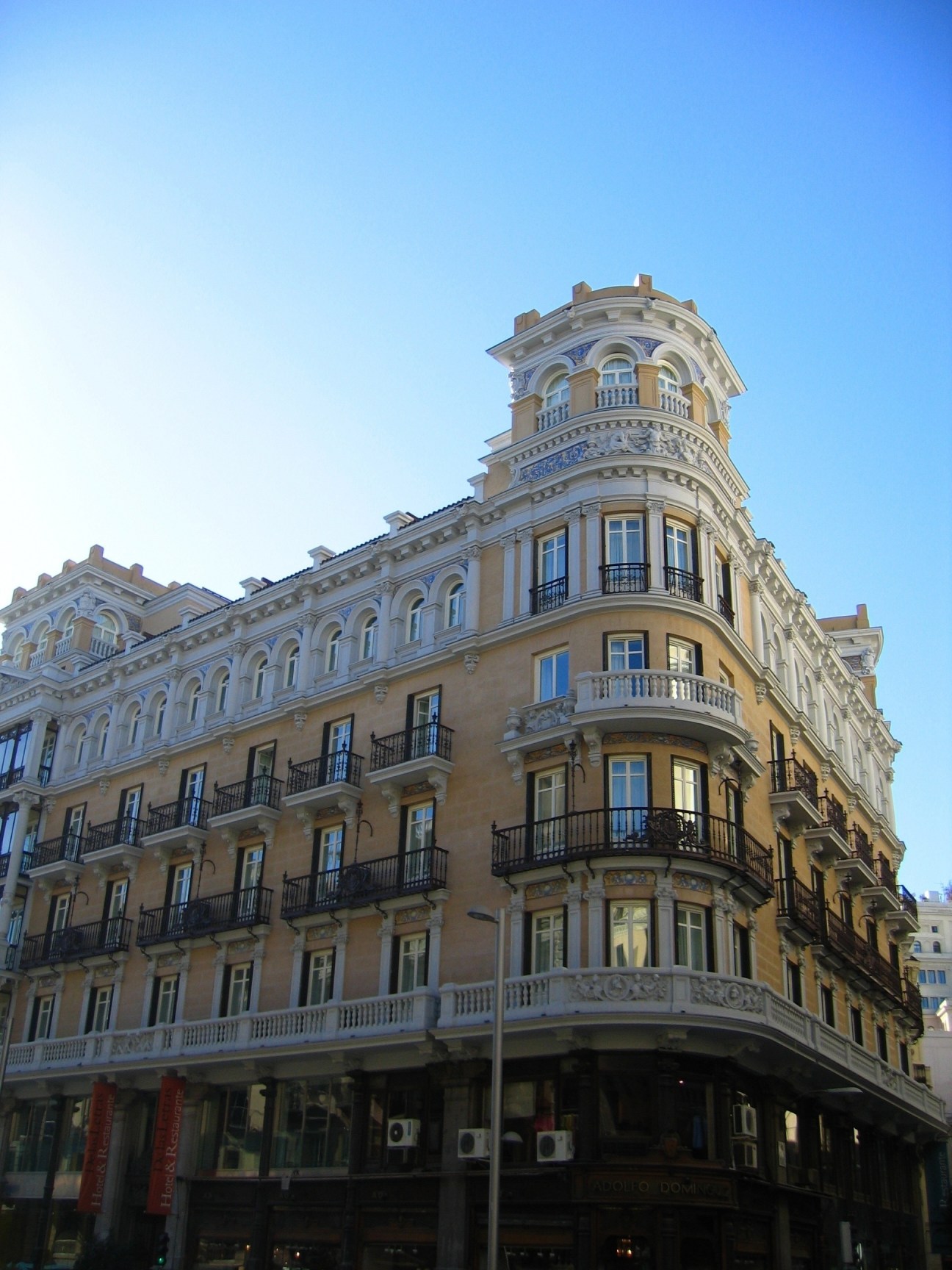 Hotel de las Letras, a grand Beaux-Arts building with ornate balconies and a distinctive turret in Madrid.