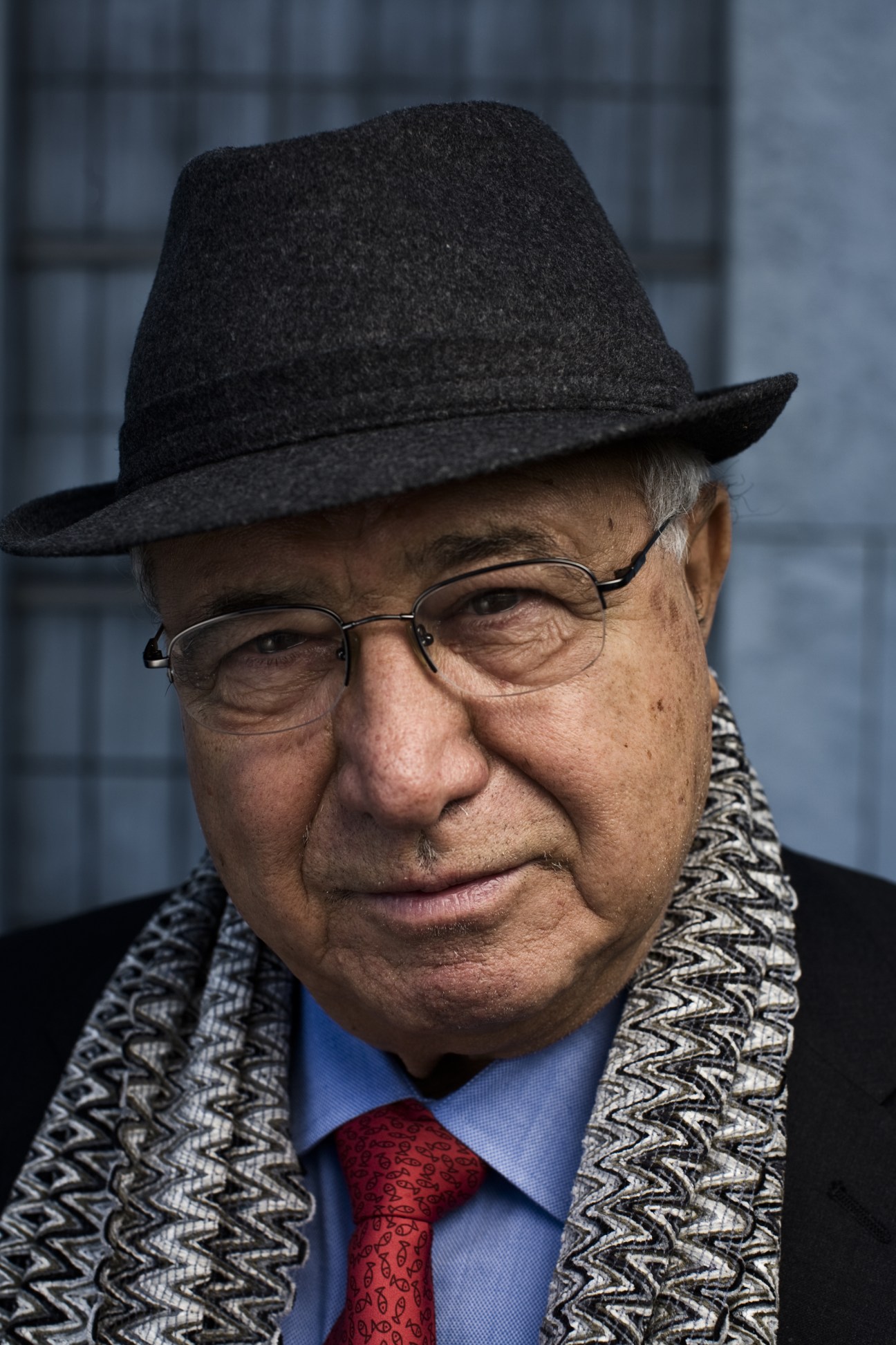 Samir Sanbar, former UN head of public information, wearing glasses and a black hat with patterned scarf
