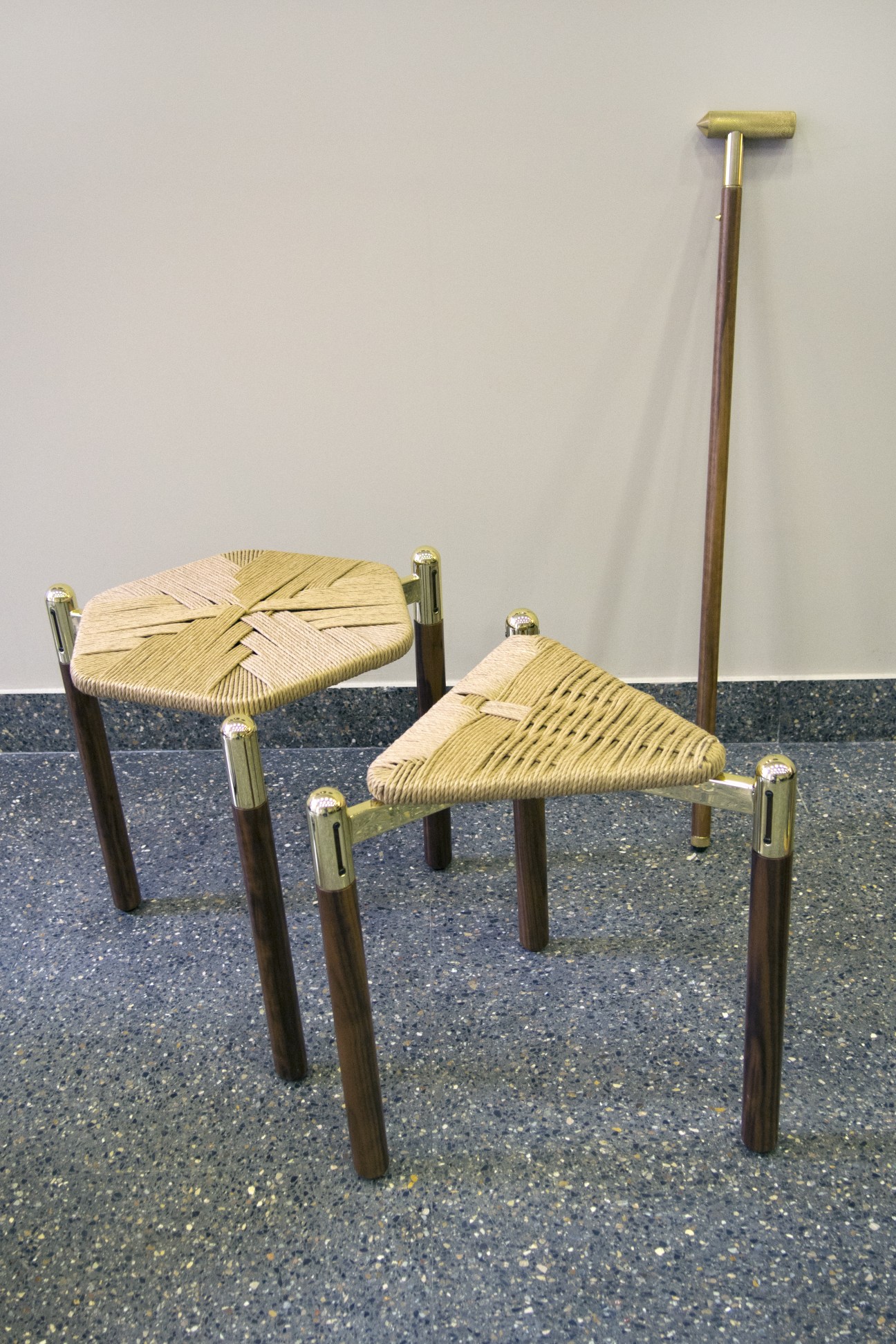 David/Nicolas's straw stools with woven seats and wooden legs, displayed with a T-cane.