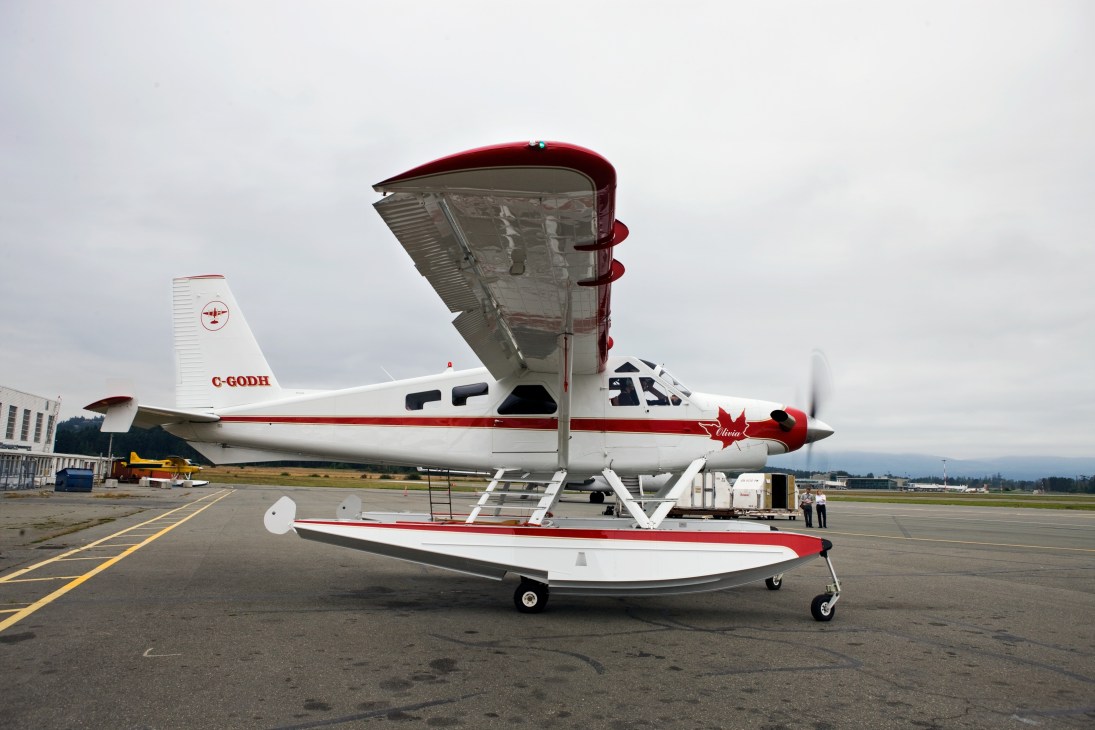 Olivia, a restored de Havilland DHC-2 Beaver with red and white paint scheme, parked on an airfield with floats attached.
