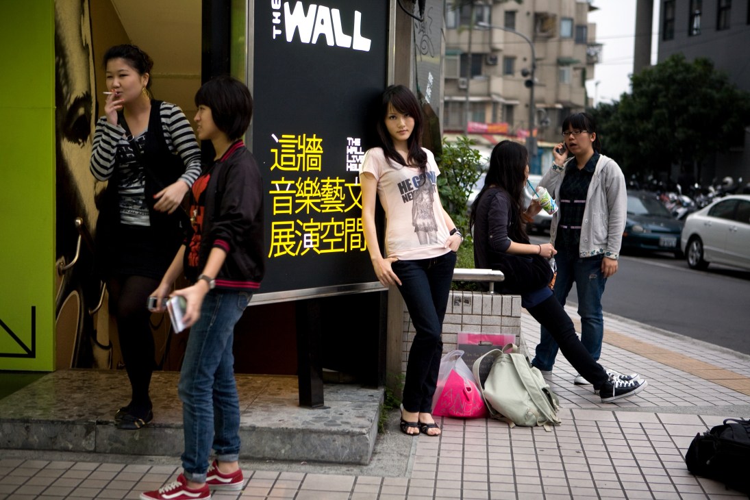 Young people hang out outside The Wall venue in Taipei's Shin Men Ding district